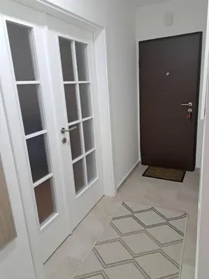 a hallway with a door and a door with glass at Mina in Budva