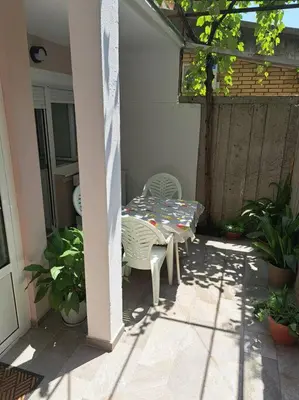a patio with a table and chairs on a porch at Mina in Budva