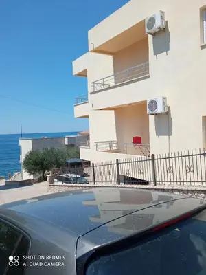 a car parked in front of a building at APARTMANI LUX SEA in Utjeha