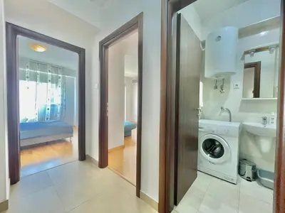 a bathroom with a washing machine and a sink at Comfort Apartments Aleksic in Budva