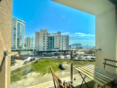 a balcony with a bench and a view of a city at Comfort Apartments Aleksic in Budva