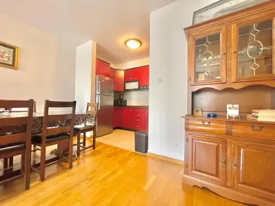 a kitchen and dining room with a table and cabinets at Comfort Apartments Aleksic in Budva