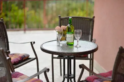 a table with a bottle of wine and two glasses at Apartment Gara in Kotor