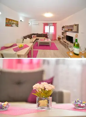 a living room with a couch and a table with flowers at Apartment Gara in Kotor
