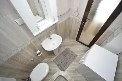 a bathroom with a white sink and a toilet at Apartment Gara in Kotor
