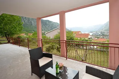 a balcony with a table and chairs and a view at Apartment Gara in Kotor