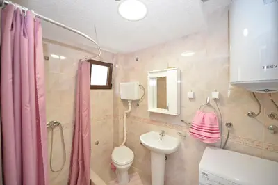 a bathroom with a sink and a toilet and a shower at Apartment Gara in Kotor
