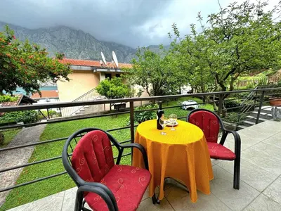 a table and chairs on a balcony with a view at Apartments Andrija in Kotor