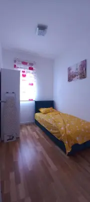 a bedroom with a bed and a window at RELAX in Podgorica