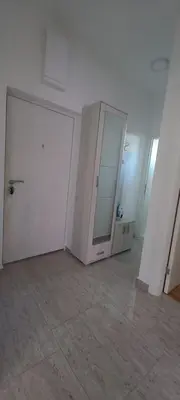 an empty room with two white doors and a mirror at RELAX in Podgorica