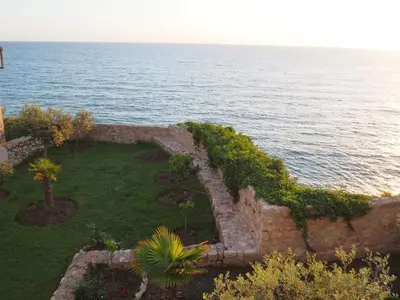 an aerial view of a garden next to the ocean at Apartments Susanna in Ulcinj