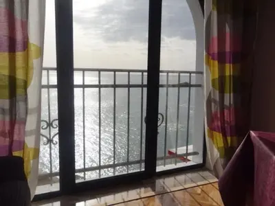 a room with a view of the ocean from a balcony at Apartments Susanna in Ulcinj