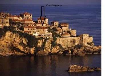 a castle on top of a cliff in the water at Apartments Susanna in Ulcinj