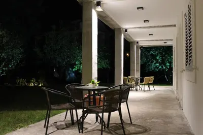 a table and chairs on a patio at night at Apartments Grgurević in Kotor