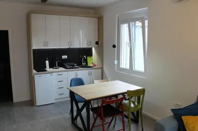 a kitchen with a table and chairs in a room at Apartments Grgurević in Kotor