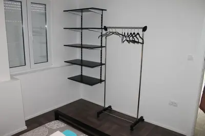 a room with black shelves in a white wall at Apartments Grgurević in Kotor