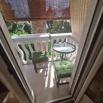 a balcony with a table and two chairs and a table at Apartments Vinka&Mila in Sutomore