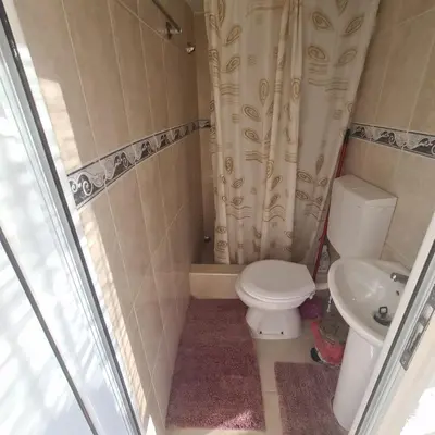 a bathroom with a toilet and a shower curtain at Apartments Vinka&Mila in Sutomore