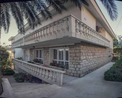a house with a staircase on the side of it at Apartments Vinka&Mila in Sutomore