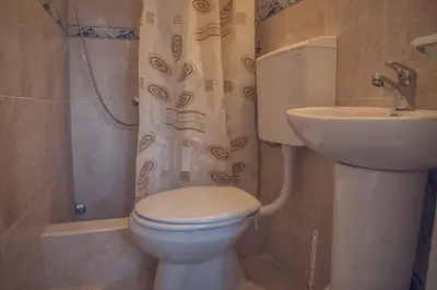 a bathroom with a toilet and a sink at Apartments Vinka&Mila in Sutomore