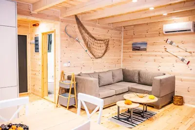 a living room with a couch and a table at Congo Bungalow in Ulcinj