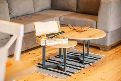 a living room with two tables and a couch at Congo Bungalow in Ulcinj