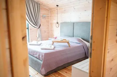 a bedroom with a bed with a table in it at Congo Bungalow in Ulcinj