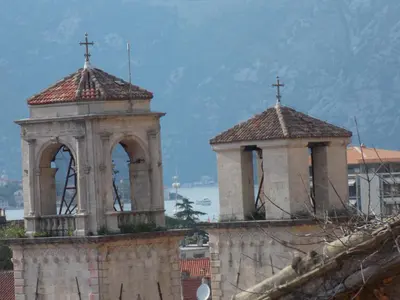 two towers with crosses on top of a building at Apartment Pela in Kotor
