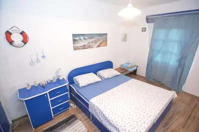 a bedroom with a blue bed and a blue dresser at Apartment Pela in Kotor