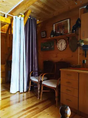 a room with two chairs and a clock on a wall at Holiday Home Bojanka in Ulcinj