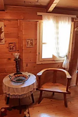 a room with a table and a chair and a window at Holiday Home Bojanka in Ulcinj