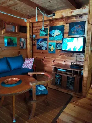 a living room with a couch and a table and a tv at Holiday Home Bojanka in Ulcinj
