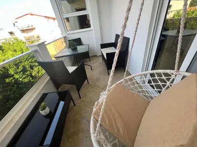 a swing in a room with a balcony at Apartments Pericic in Sutomore