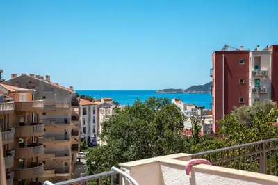 a view of the city from the balcony of a building at Olive Garden Apartments in Sveti Stefan