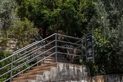 a set of stairs with a sign on it at Olive Garden Apartments in Sveti Stefan