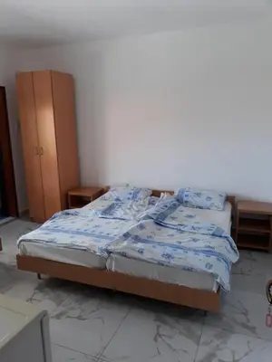 a bedroom with a bed with a blue comforter at Guest House Sandra in Kotor