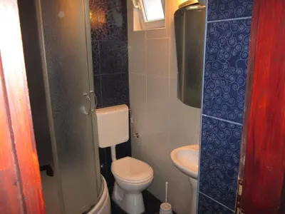 a small bathroom with a toilet and a sink at Guest House Sandra in Kotor