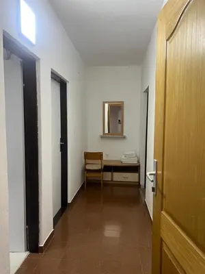 a hallway with a table and a mirror in a room at Apartments Kordic in Budva
