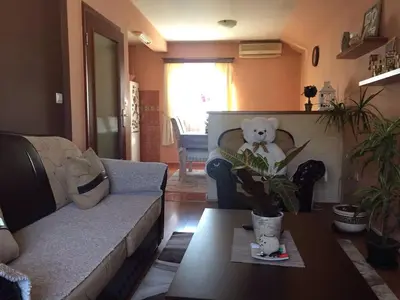 a living room with a couch and a teddy bear on a table at Apartments Kordic in Budva
