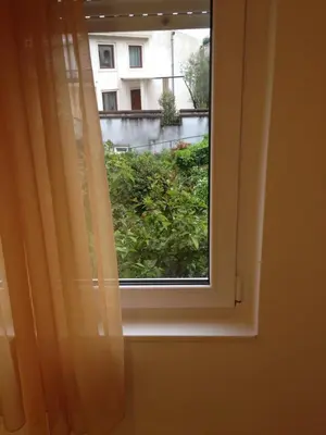 a window with a view of a building at Apartments Kordic in Budva