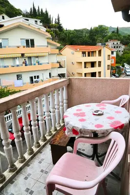 a table and chairs sitting on a balcony at Apartments Kordic in Budva