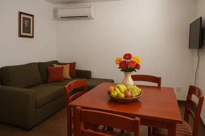 a living room with a table with a bowl of fruit at Apartments Villa Mirjana in Budva