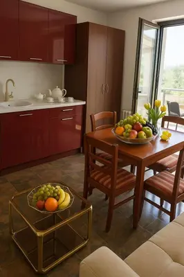 a kitchen with a table with a bowl of fruit on it at Apartments Villa Mirjana in Budva