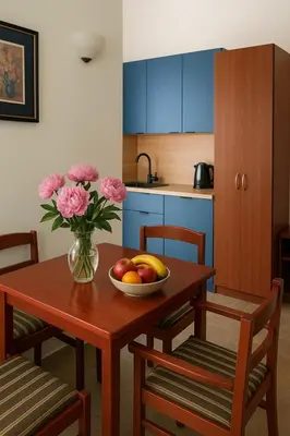 a kitchen with a wooden table with a bowl of fruit on it at Apartments Villa Mirjana in Budva