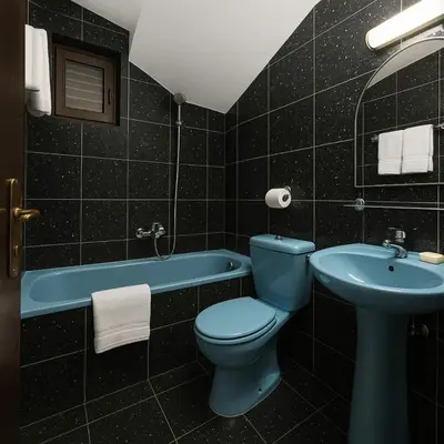 a bathroom with a blue toilet and a sink at Apartments Villa Mirjana in Budva