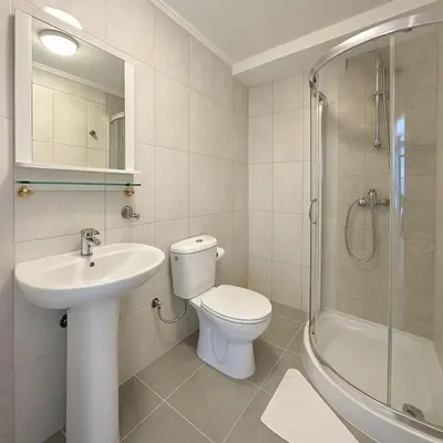a bathroom with a toilet and a sink and a shower at Apartments Villa Mirjana in Budva