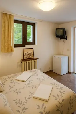 a bedroom with a bed with two towels on it at Apartments Villa Mirjana in Budva