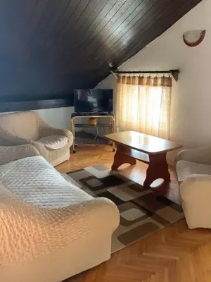 a living room with a couch and a coffee table at Apartments Dunja in Sveti Stefan