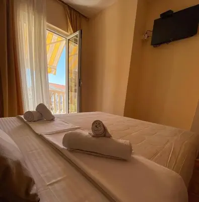 a bed with towels on it with a window at Apartments Dunja in Sveti Stefan