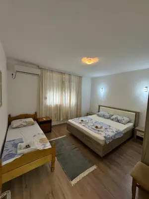 a bedroom with two beds and a window at Berin Apartments in Ulcinj